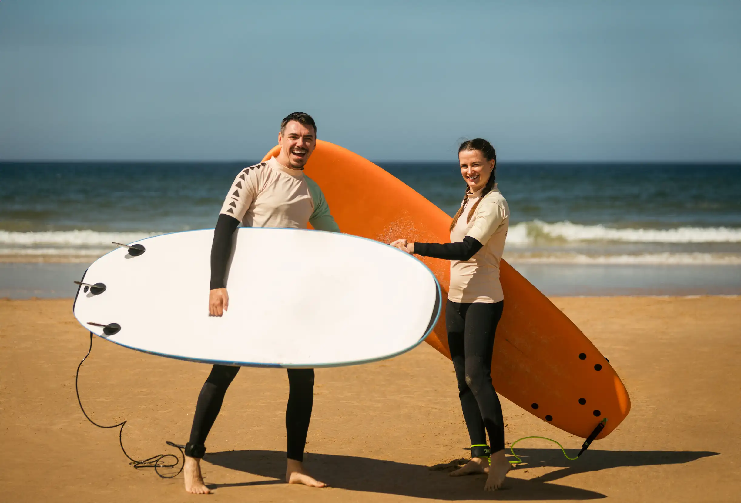 Couple surf lessons Tamarindo with certified instructor in water