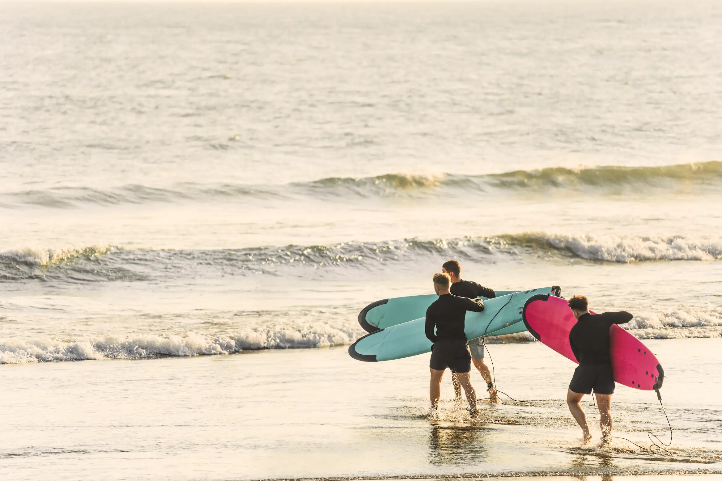 Group surf lessons Tamarindo — students lining up with boards