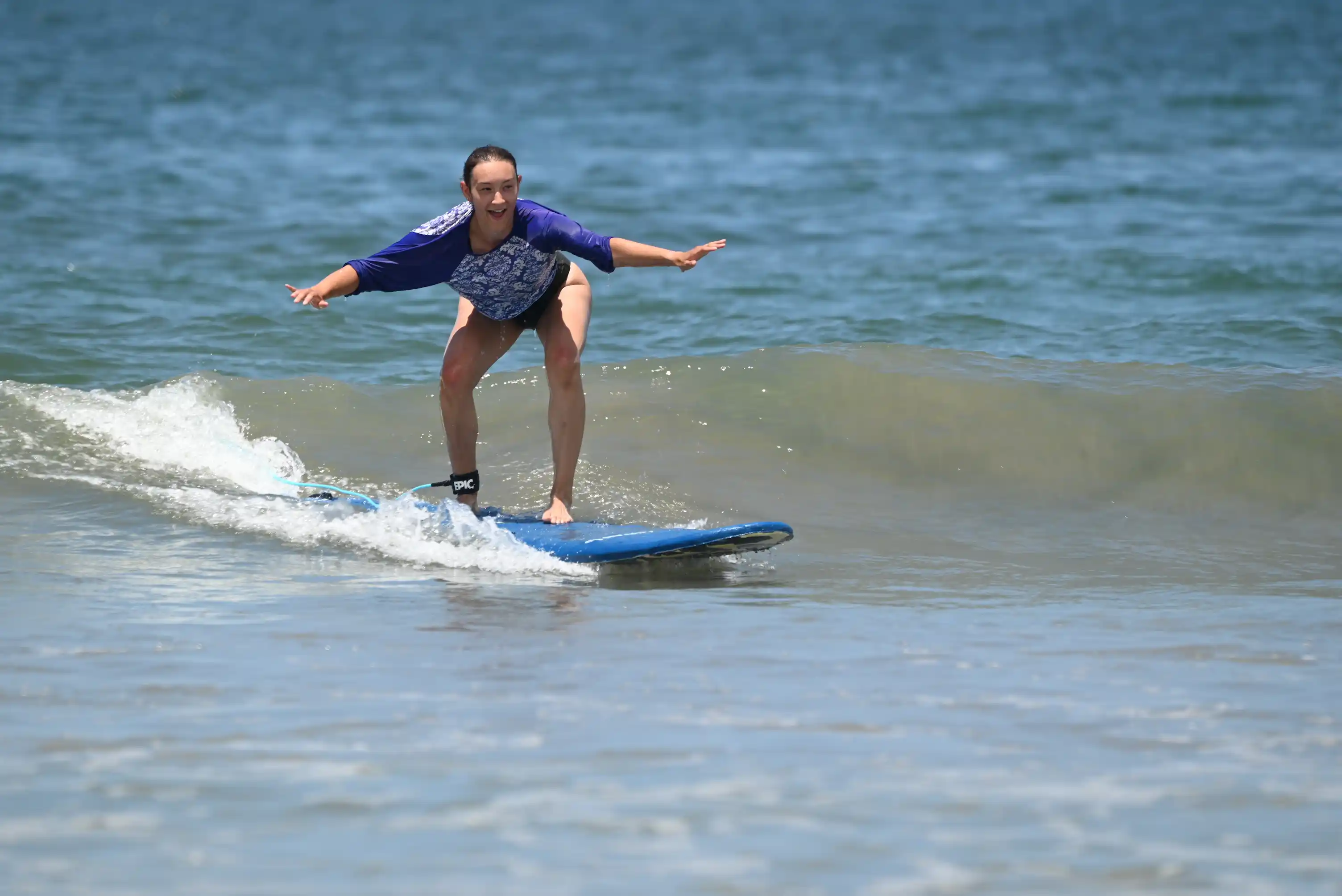Tamarindo surf student riding an unbroken green wave
