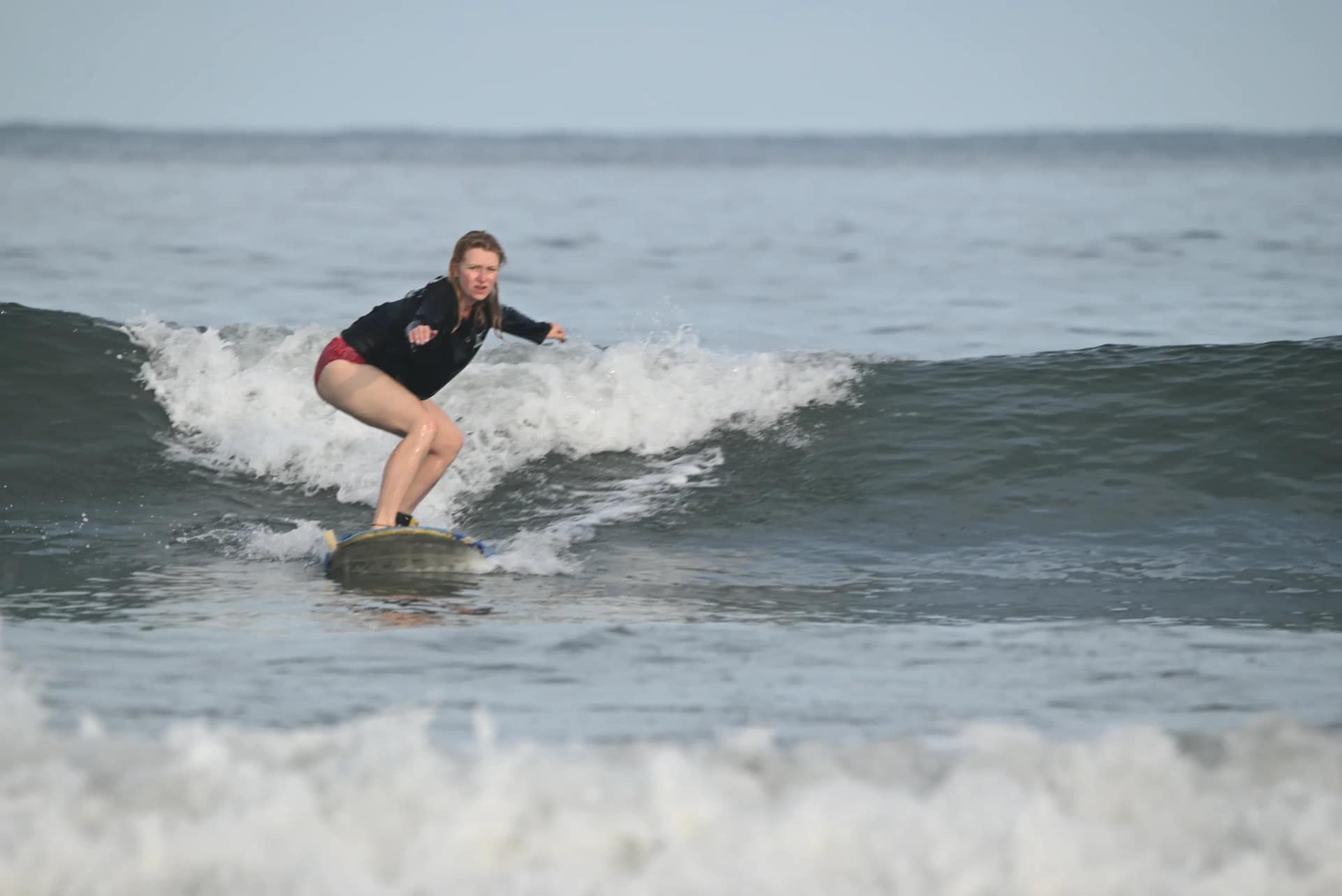 Beginner taking the first lesson of a 3-day surf package in Tamarindo