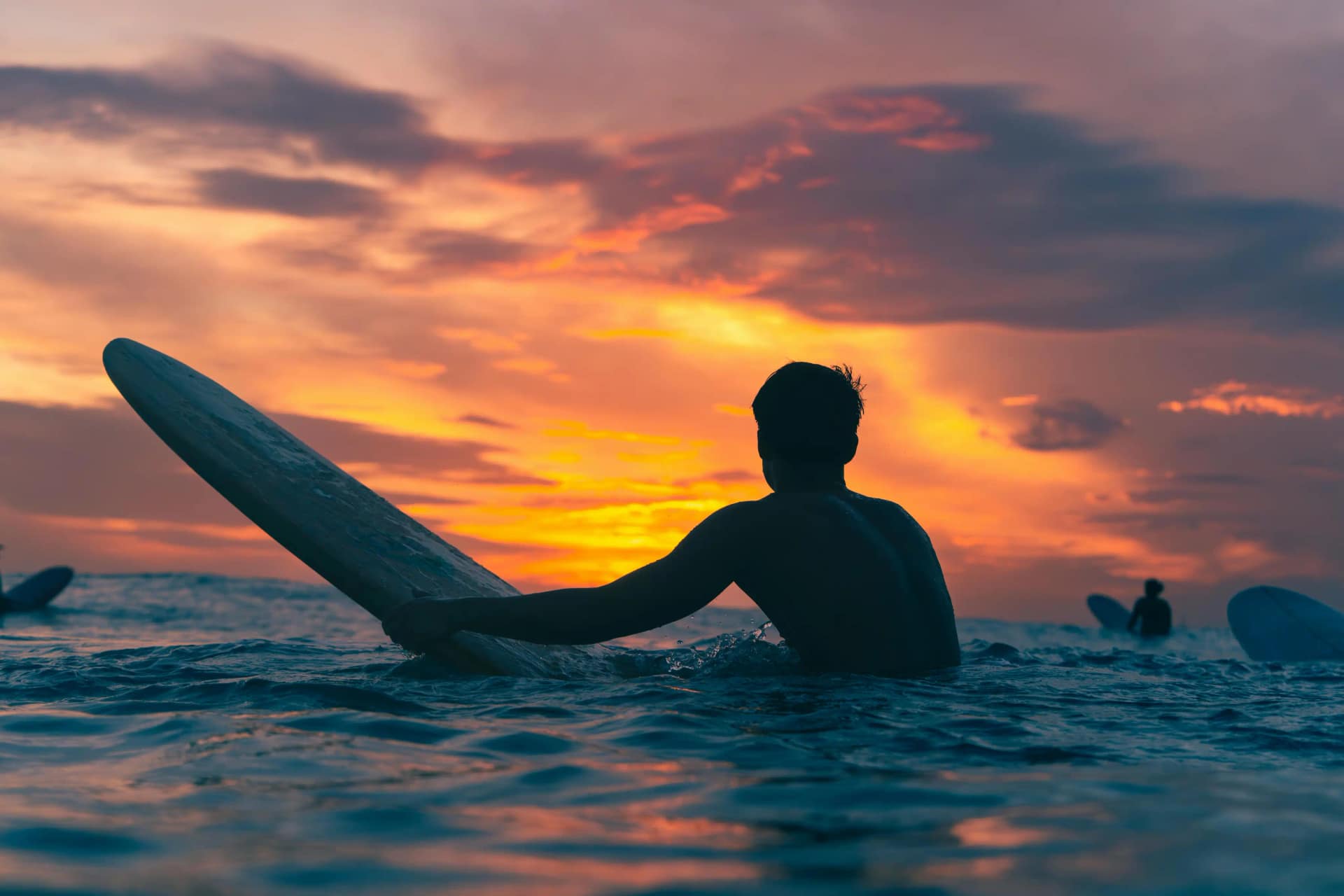 Surfers at sunset on Tamarindo beach, Costa Rica