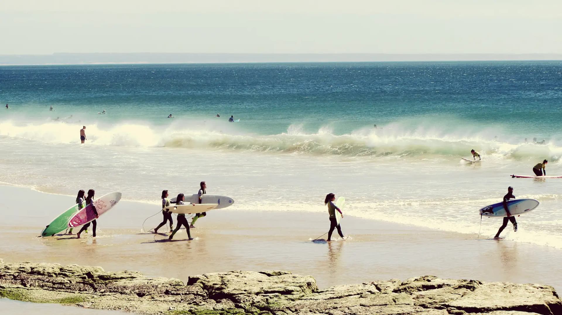 Group surf class in session on Tamarindo beach, Costa Rica