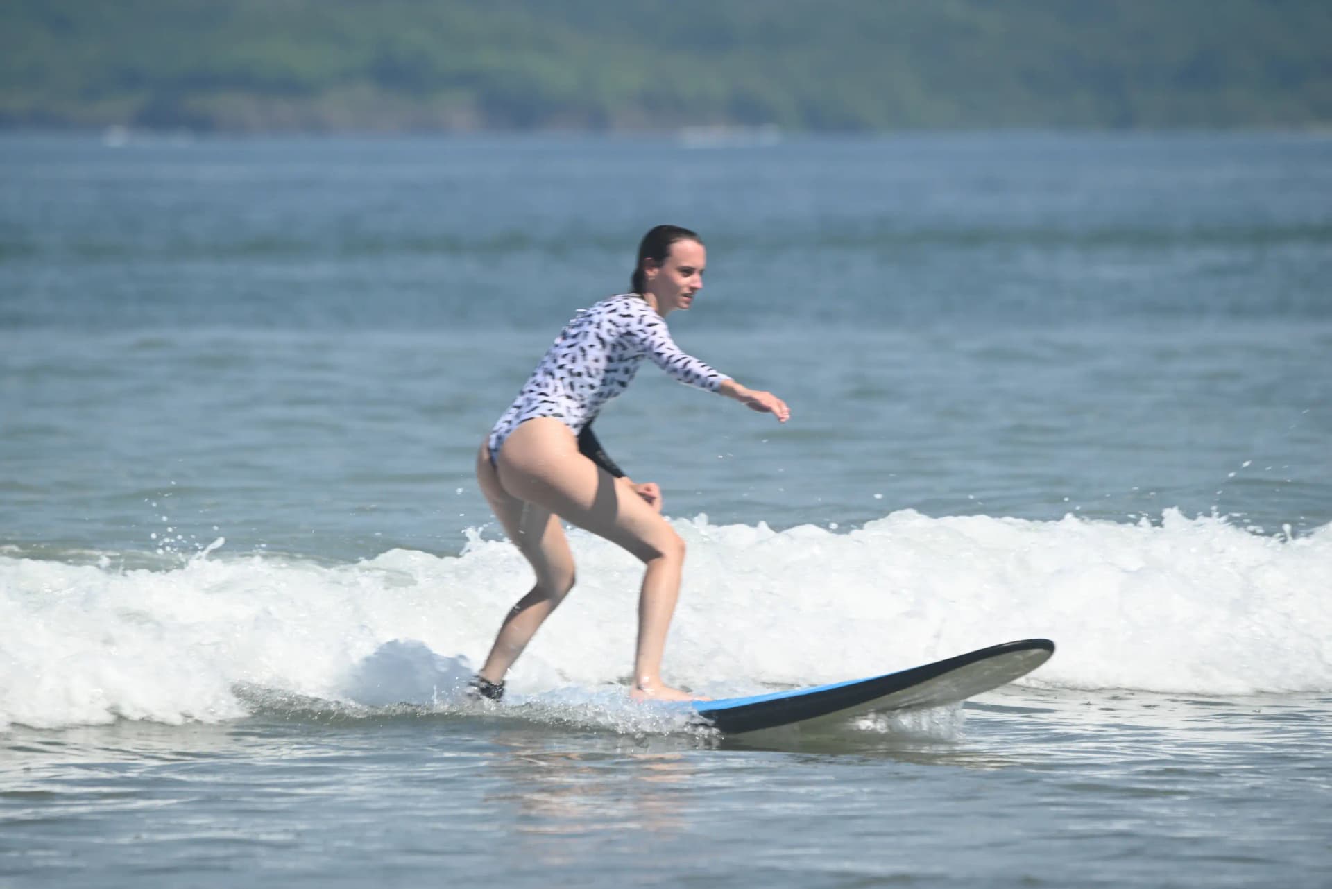 Instructor coaching a student one-on-one during a private surf class in Tamarindo